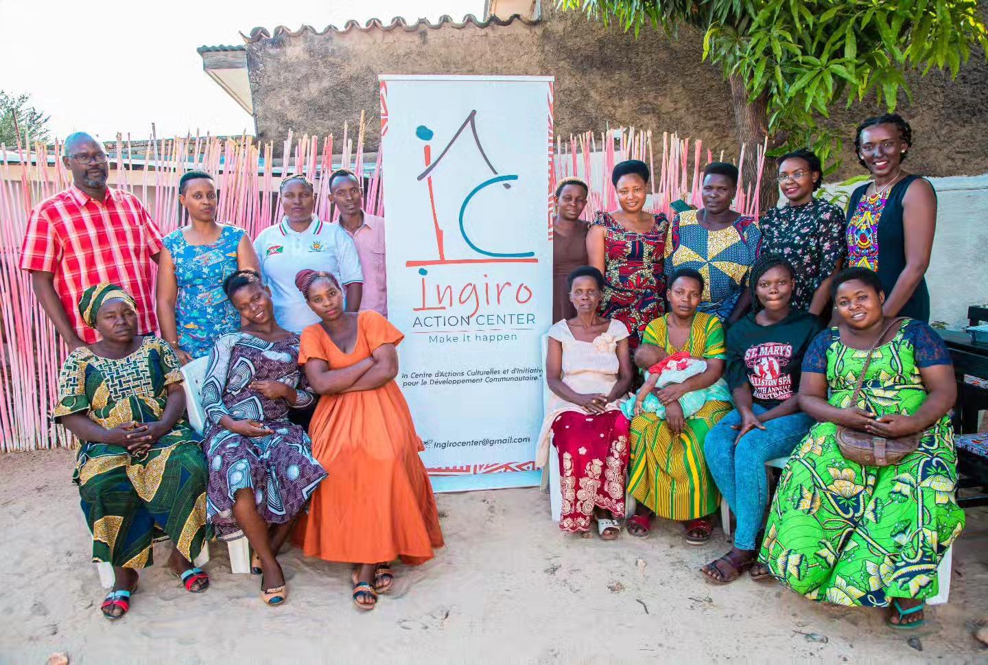 A group poses for a photo in a meeting room with an Ingiro banner.