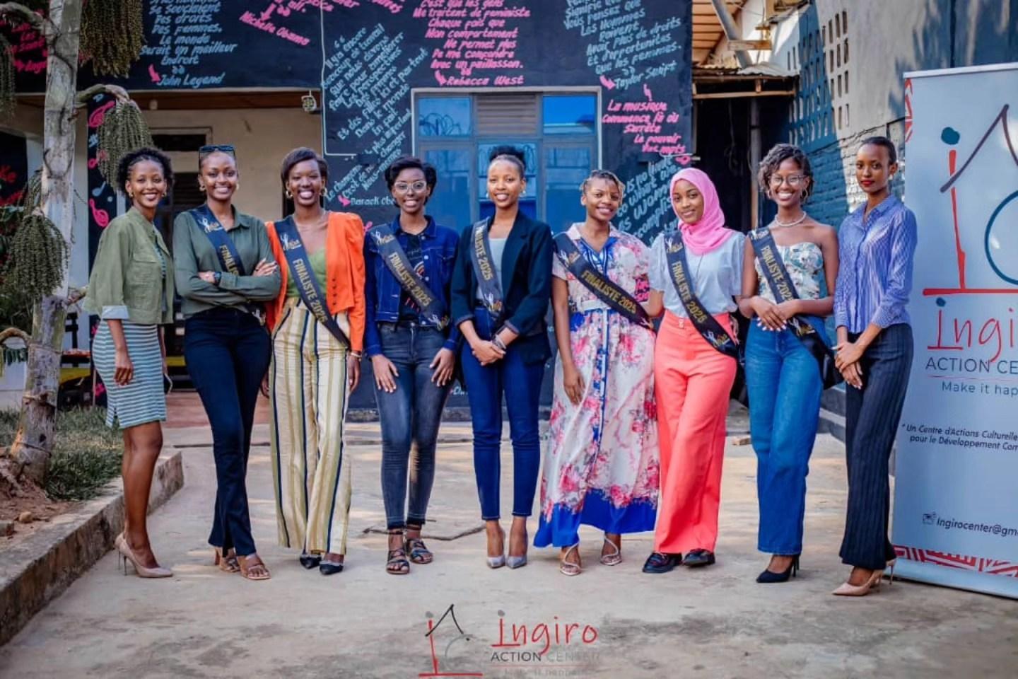 A group of women stand together in a studio in front of an Ingiro Action Center sign.