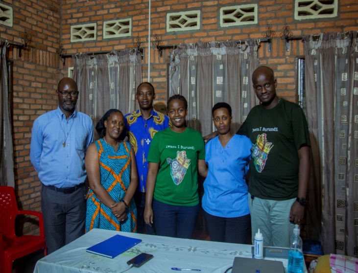 Six personnes se posent ensemble dans une pièce à côté d'une table avec des fournitures médicales.